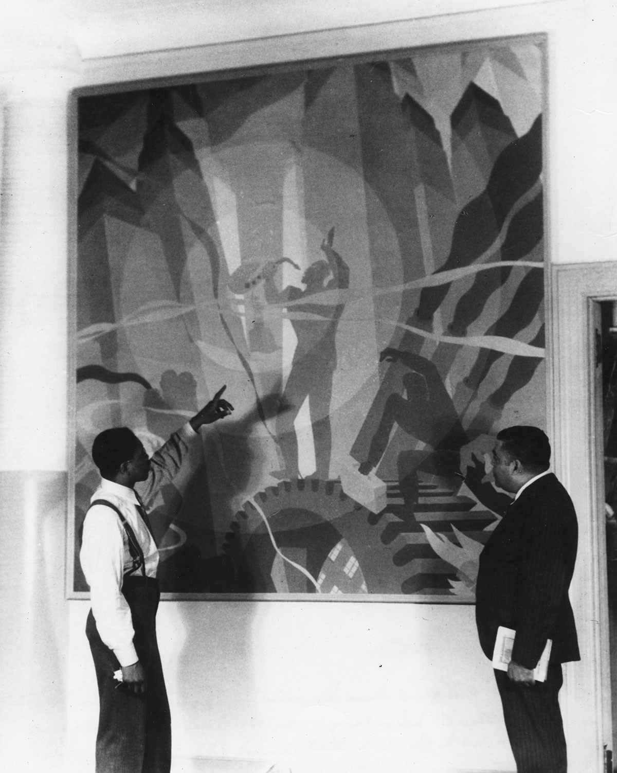 Aaron Douglas (left) discusses his new painting “Song of the Towers” in 1934 with Schomburg Collection curator Arturo Alfonso Schomburg. (Photo: The New York Public Library, Schomburg Center for Research in Black Culture, Art and Artifacts Division) McFadden_NYPL_1820330u.jpg