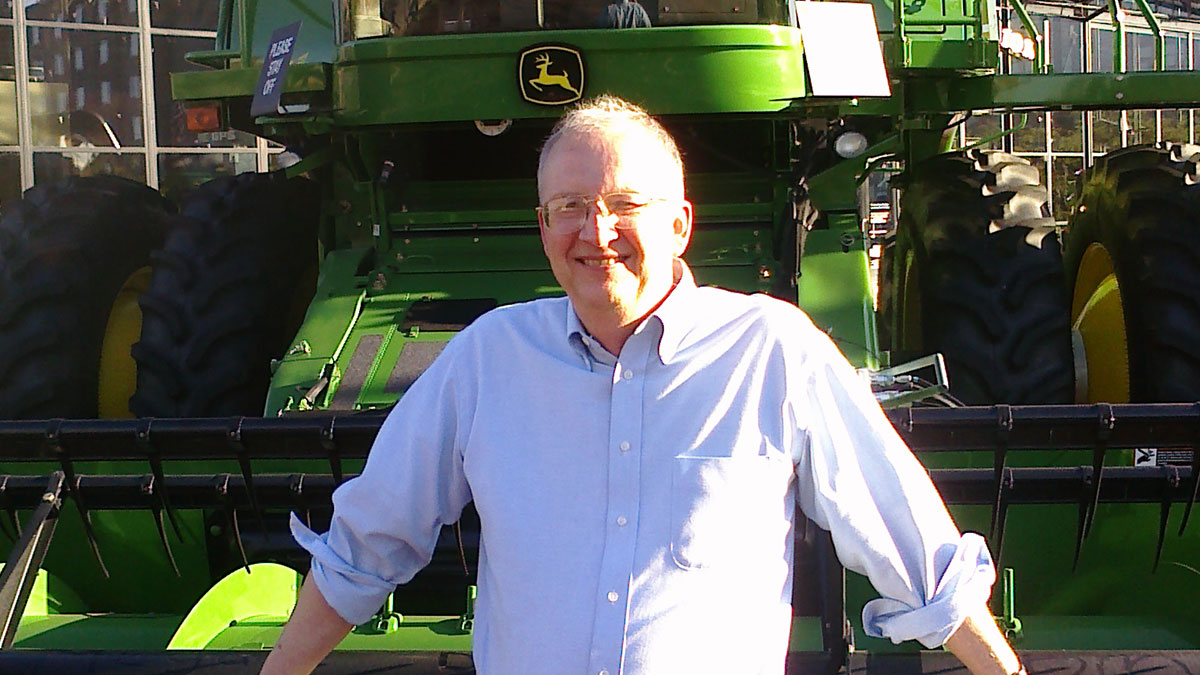 Kenneth M. Johnson stands in front of a history-making combine outside of John Deere Pavilion in Moline, Illinois. This machine was the 500,000th self-propelled combine to roll off Deere’s East Moline assembly line. (Photo: Brenda P. Johnson) AC_Fellows_Kenneth_M._Johnson_JohnDeere.jpg