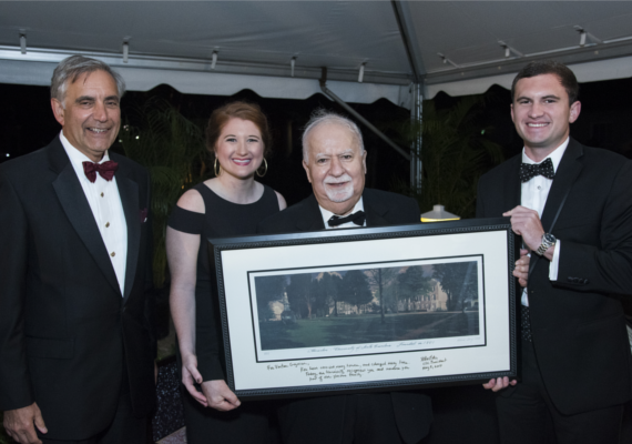 Vartan Gregorian with a signed print of the University of South Carolina's historic Horseshoe green