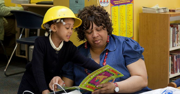 A preschooler reads to her grandmother during a Family Financial Fair at the Weequahic Branch. A preschooler reads to her grandmother during a Family Financial Fair at the Weequahic Branch.